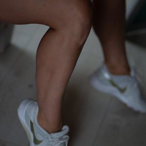 Close-up of athletic shoes on a gym floor.