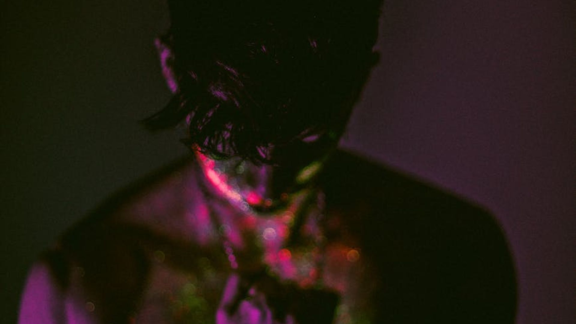 Silhouette of a man in a powerful stance against a dark background.